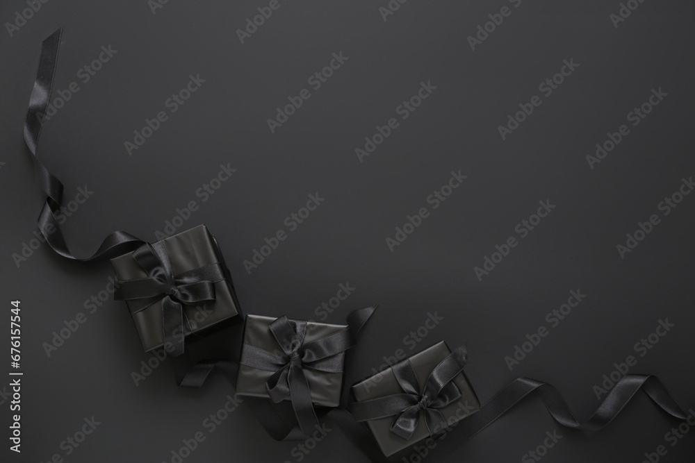 Gift boxes and ribbon on dark background. Black Friday