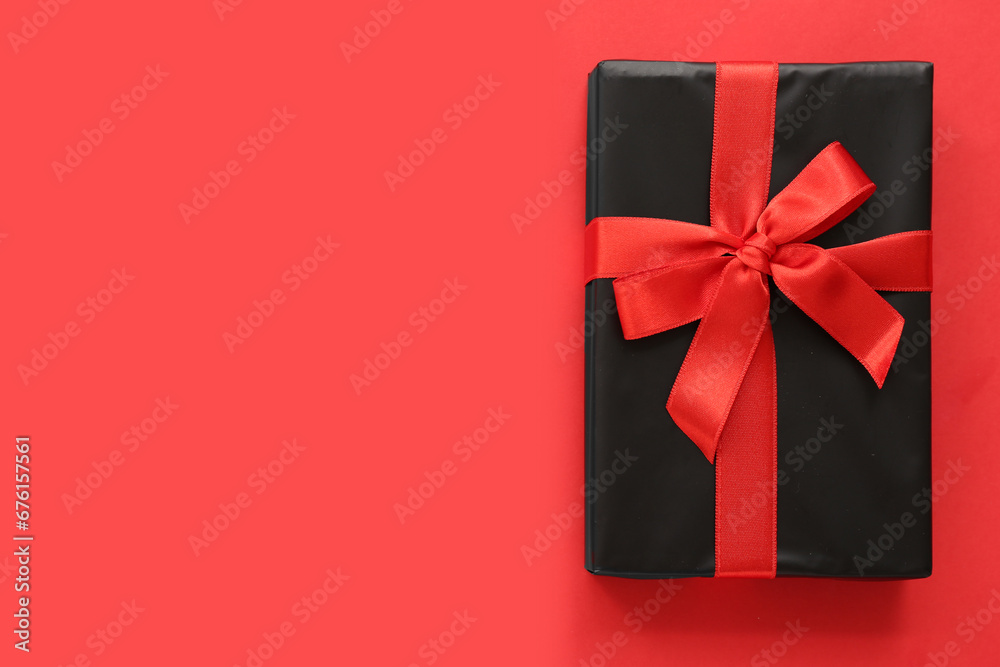 Gift box on red background. Black Friday