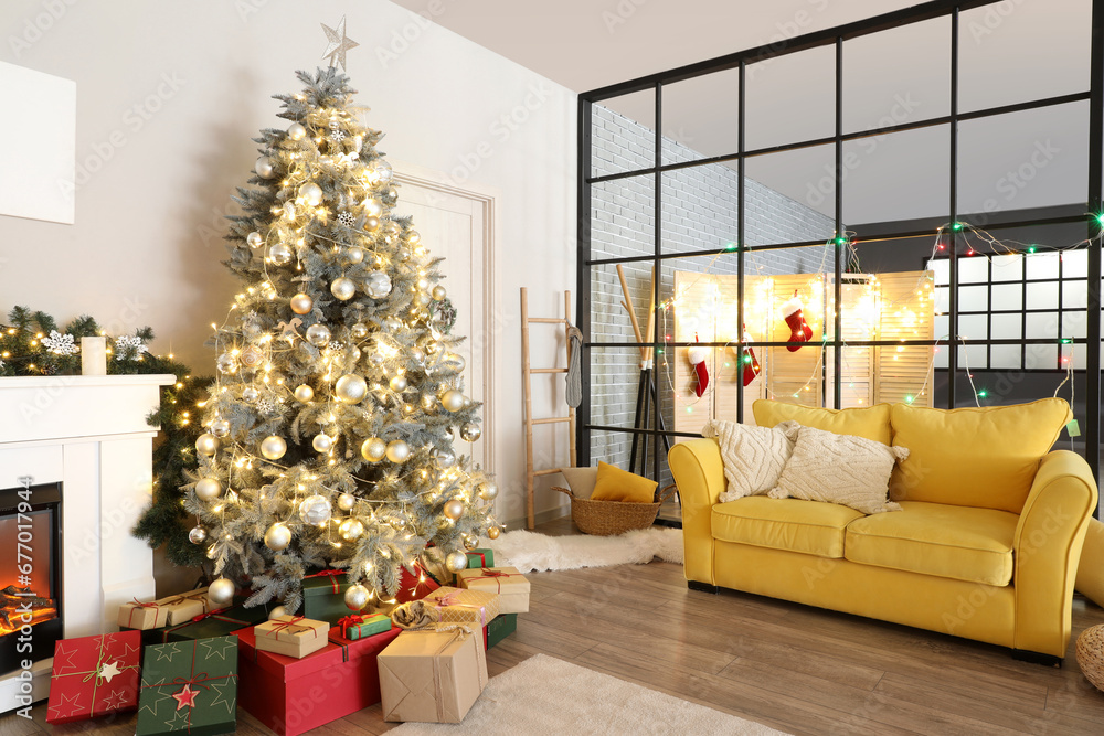 Interior of living room with Christmas tree, yellow sofa and folding screen