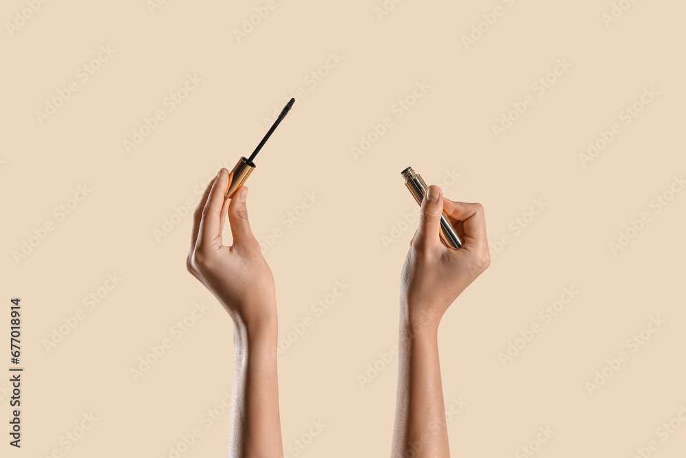 Woman with mascara on beige background