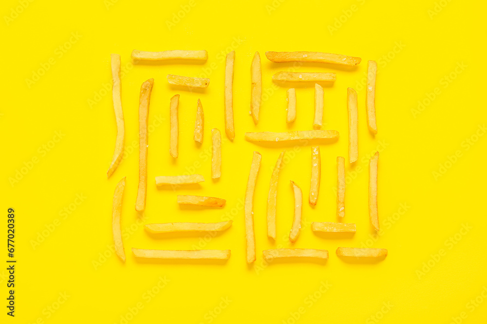 Delicious french fries on yellow background