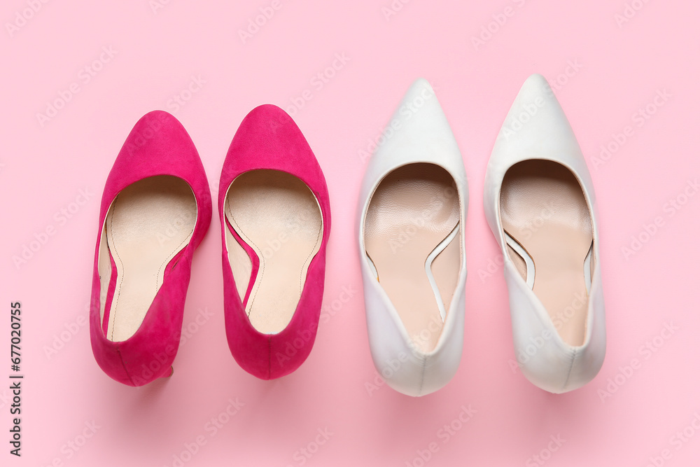 Different stylish high heels on pink background