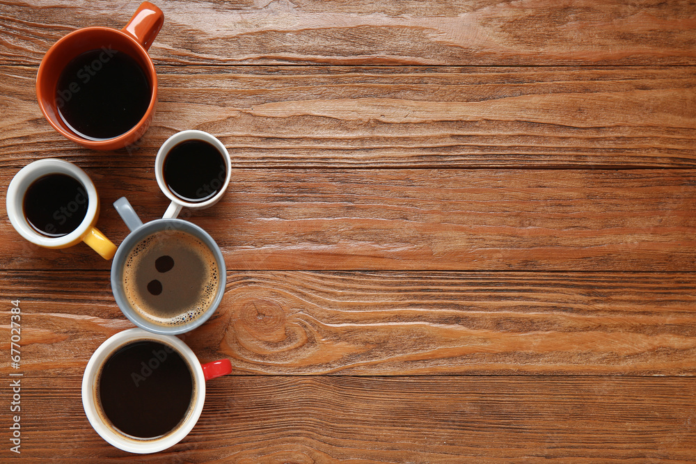 Many cups of hot coffee on wooden background