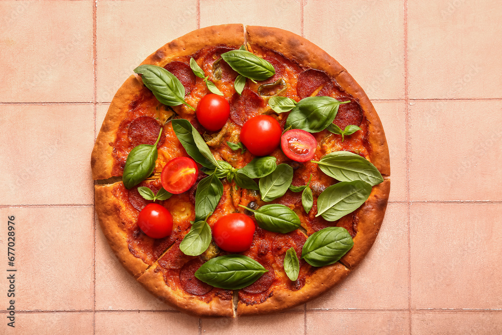 Delicious Pepperoni pizza with tomatoes and basil on pink tile background