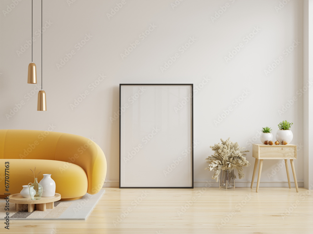 Poster mockup with vertical frame standing on floor in living room interior with yellow sofa on white wall background