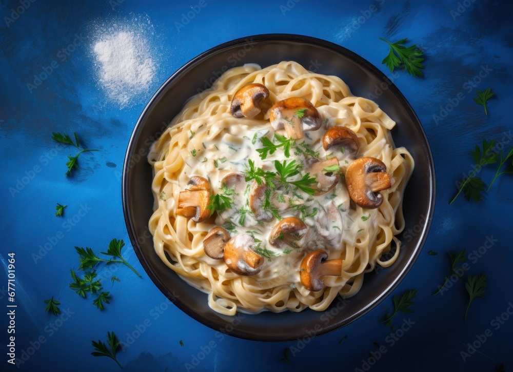 creamy salmon fettucine with mushrooms on a blue table