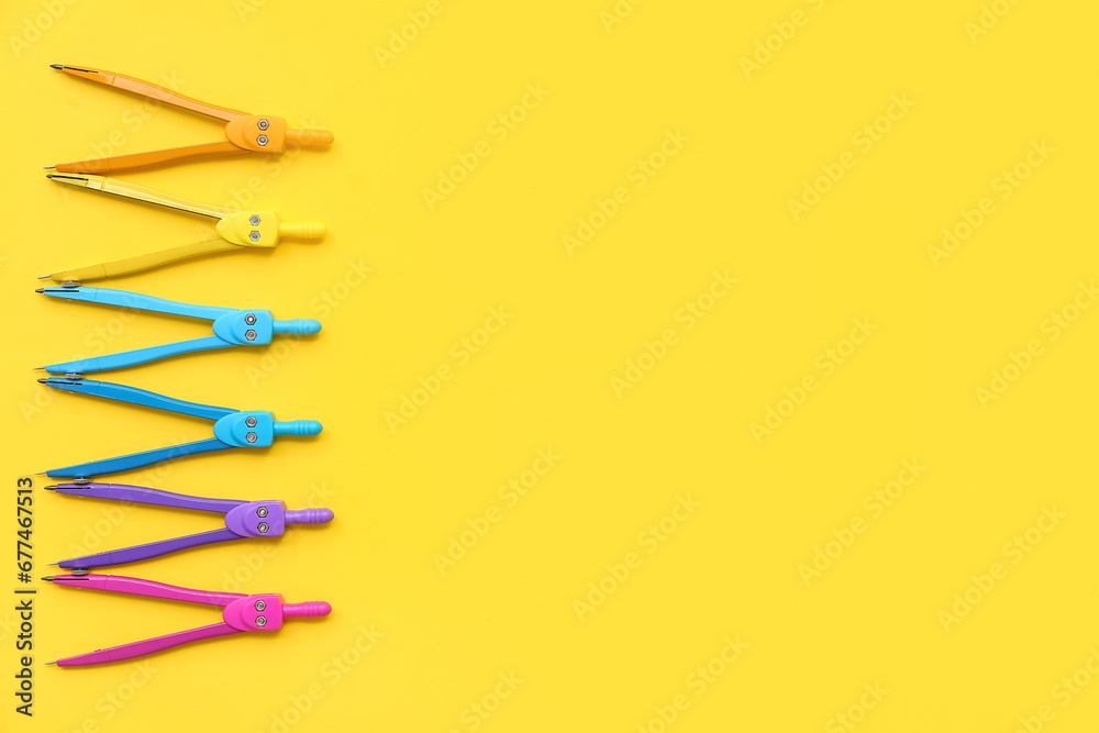 Composition with different compasses on yellow background