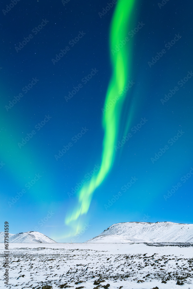 Aurora Borealis. Northern lights and clear skies. Nature. Scandinavian countries. Snow and ice on the mountains. Landscape in winter time. Photo for background and wallpaper.