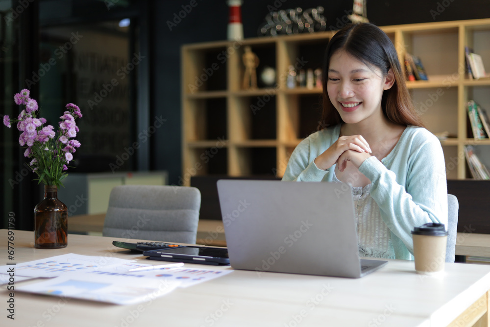 Students studying online on laptops in university library. Asian woman working with laptop in office.