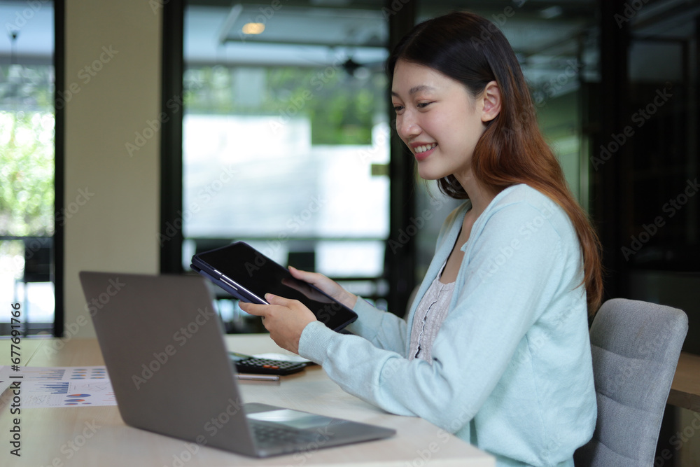 Students studying online on laptops in university library. Asian woman working with laptop in office.