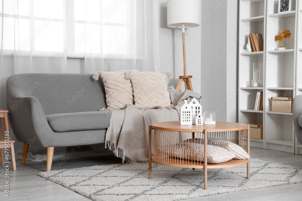 Interior of stylish living room with coffee table and cozy sofa