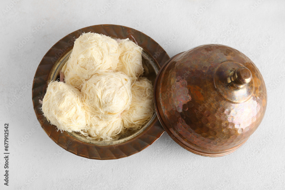 Bowl with tasty Turkish Pismaniye on white background