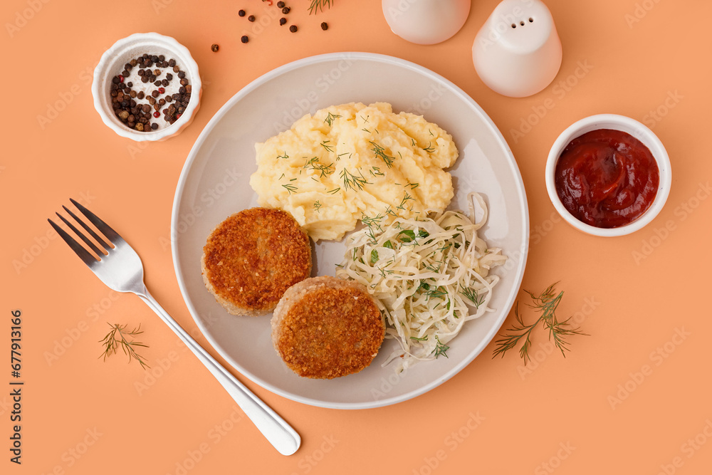 Plate of tasty meat cutlets with mashed potatoes, sauce and salad on orange background