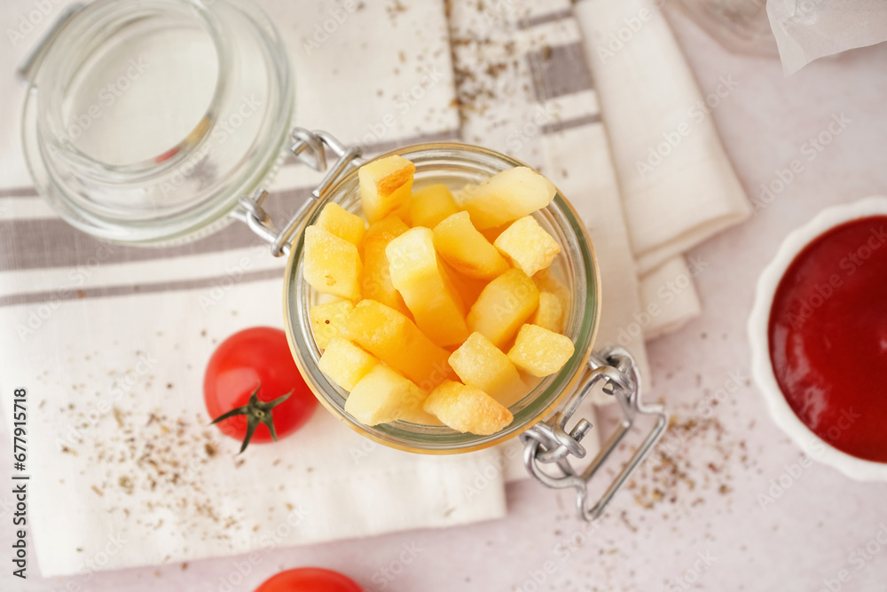 Jar of tasty french fries on white background