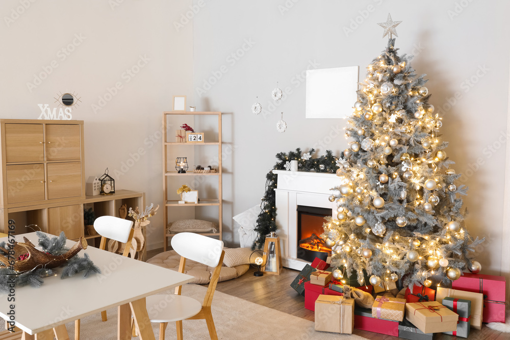 Interior of living room with dining table, Christmas tree and fireplace