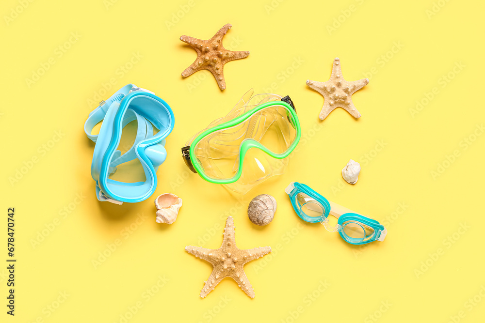 Swimming masks, seashell and starfish on yellow background