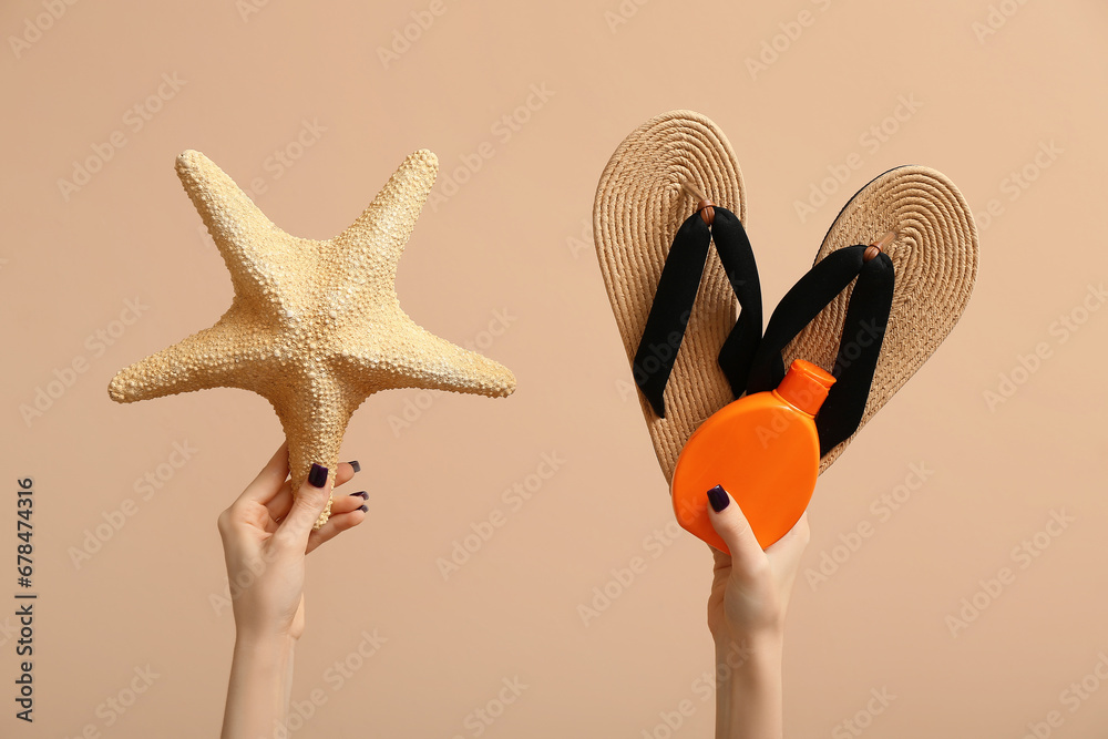 Female hands with summer accessories on beige background