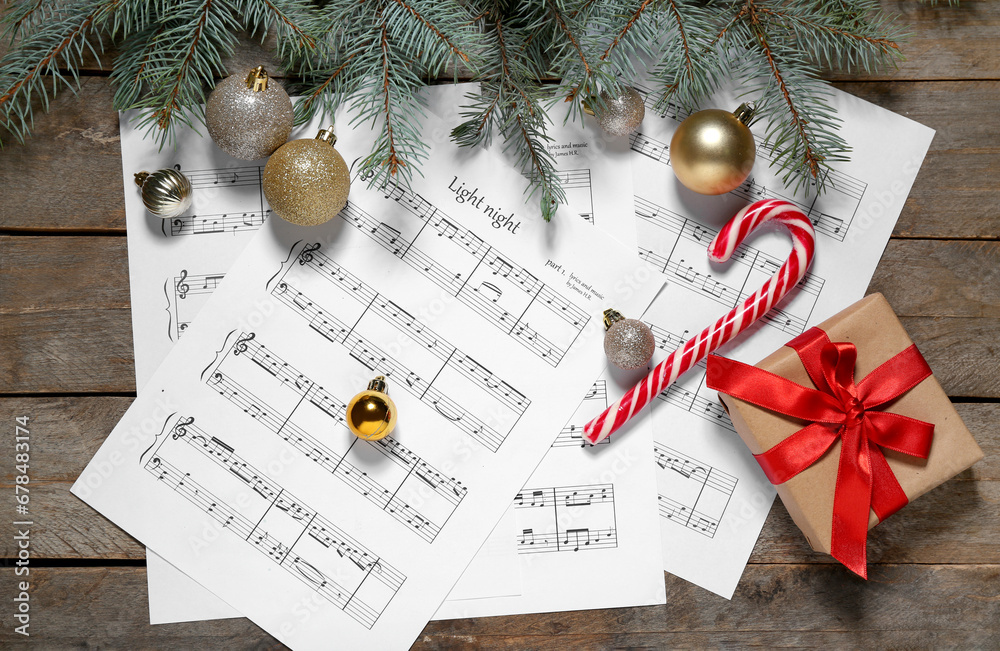 Composition with music sheets, Christmas decorations and fir branches on wooden background