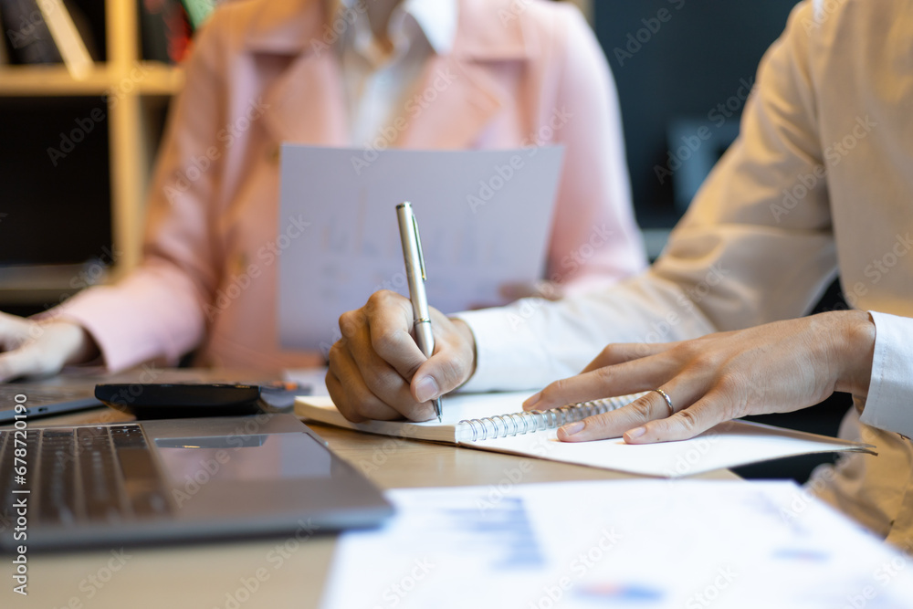 Colleagues working on paperwork in the office. Businessperson discussing the analysis of financial and accounting business reports.