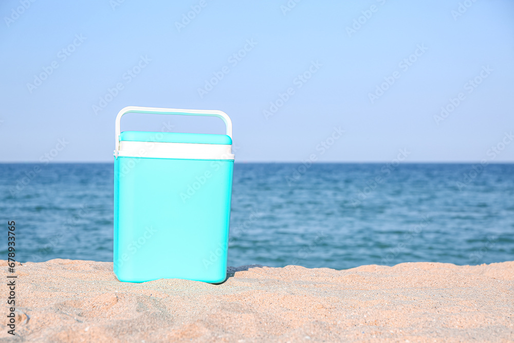 Modern beach cooler on sand