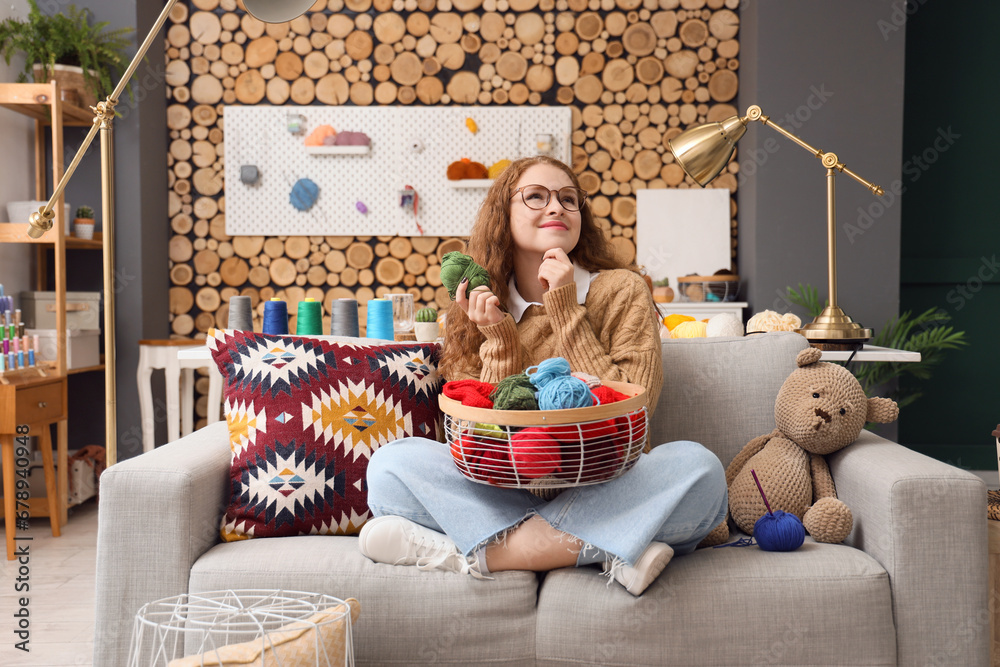 Young woman with knitting yarn at home