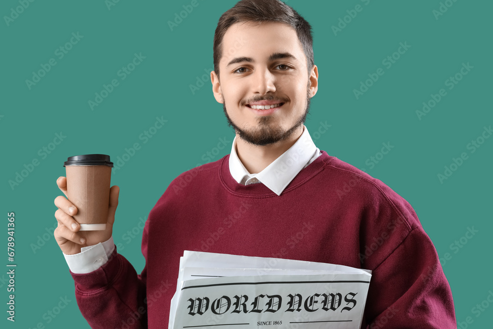 Young man with newspaper and coffee cup on green background, closeup