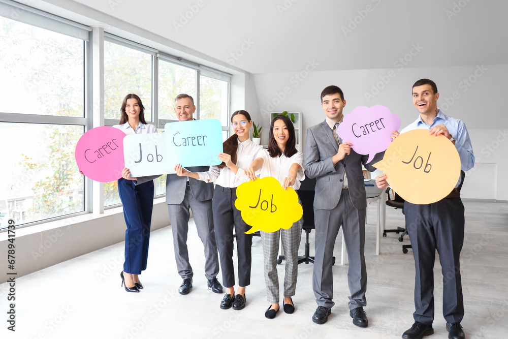 Business colleagues holding speech bubbles with words JOB and CAREER in office