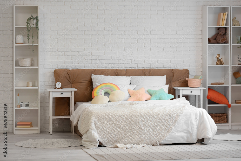 Interior of childrens room with big bed and tables