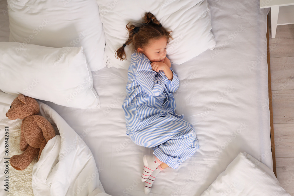 Frozen little girl sleeping on bed, top view