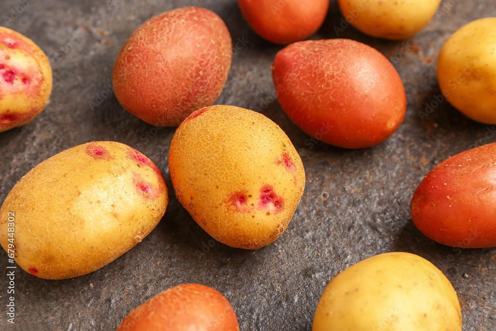 Fresh raw potatoes on dark background