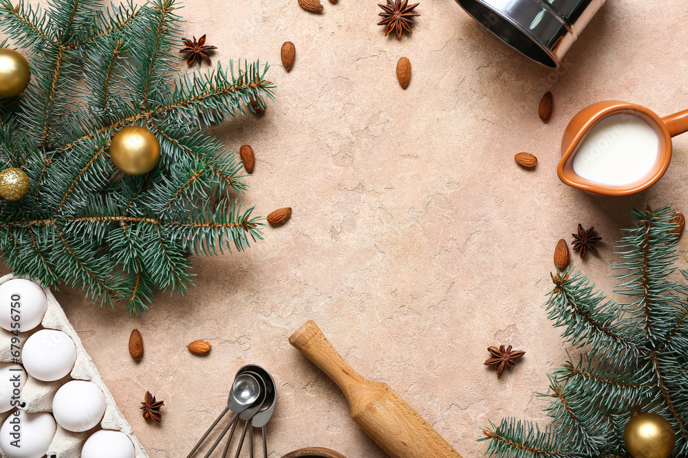 Frame made of different ingredients for preparing Christmas pie and fir branches on beige background