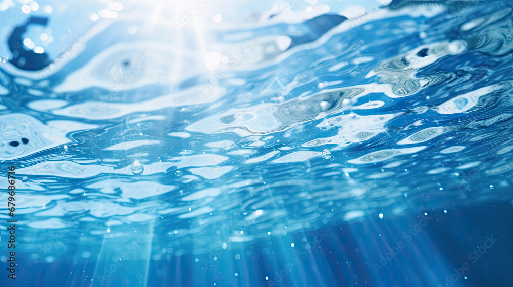 Water surface texture with bubbles and splashes that is defocused blurring transparent blue in color. Trendy abstract background of nature. The sea ripples in the sunlight