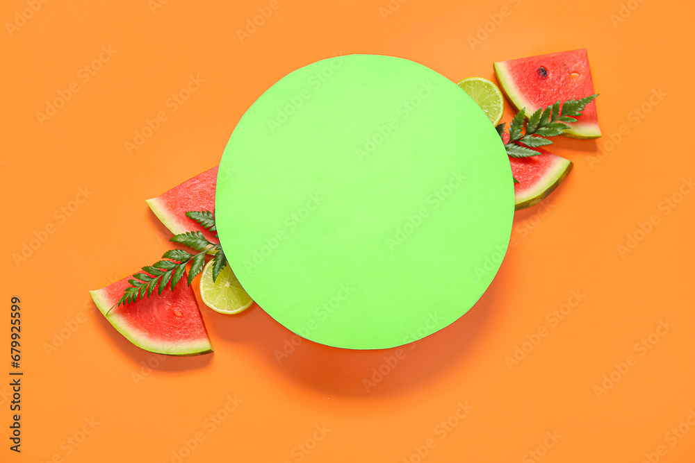 Blank card and pieces of fresh watermelon with lime on orange background