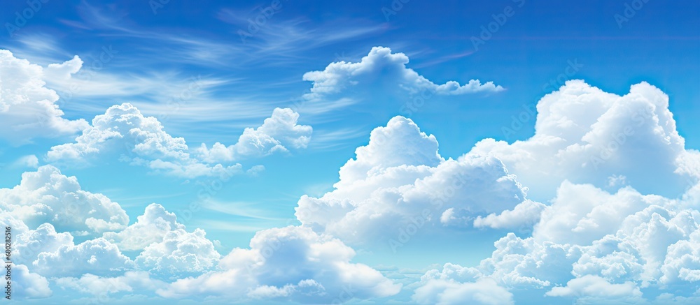 In the summer, under the bright sunlight, the blue sky adorned with white and fluffy clouds creates a beautiful and colorful scenery in the nature, making it a day of pure bliss and heavenly delights