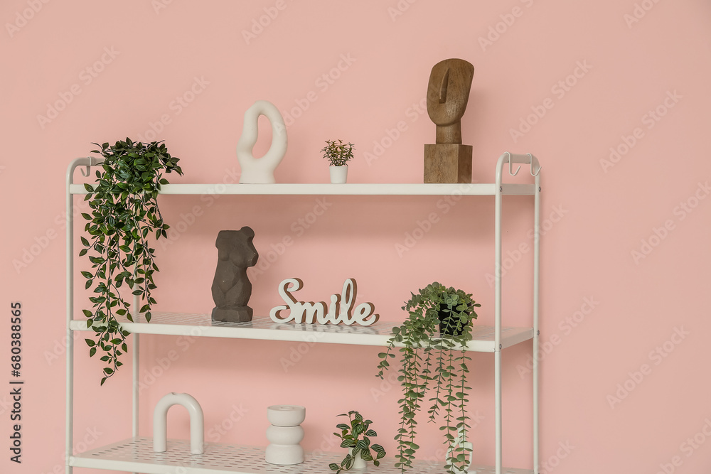 Modern shelf unit near pink wall