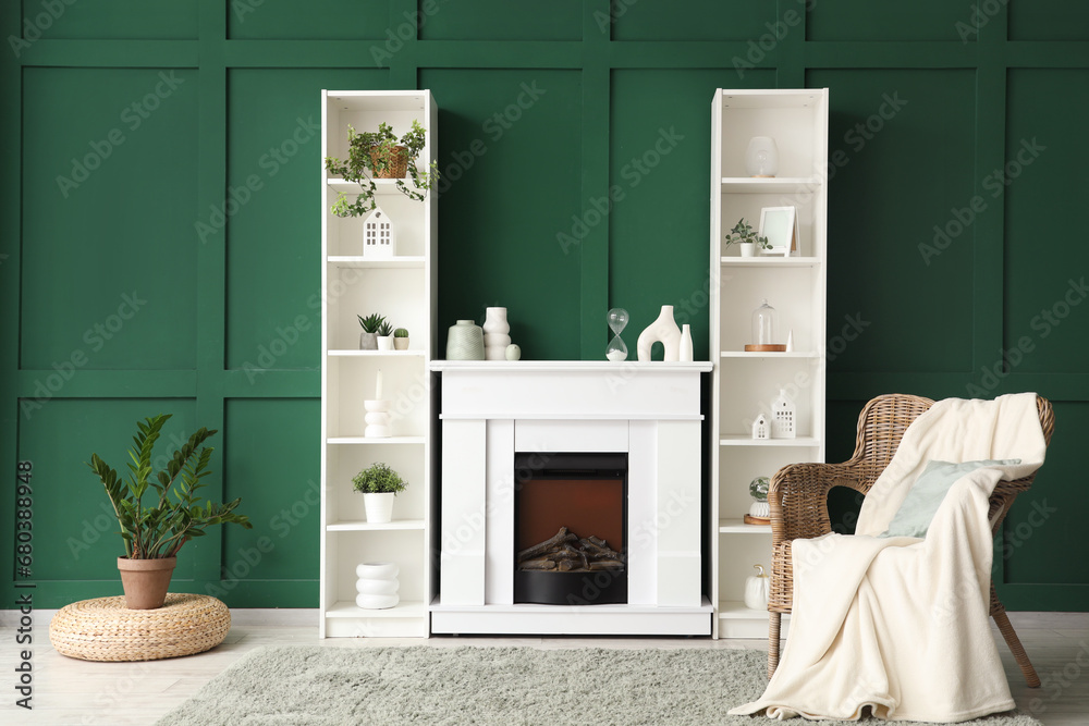 Interior of modern living room with fireplace, shelving unit and wicker armchair