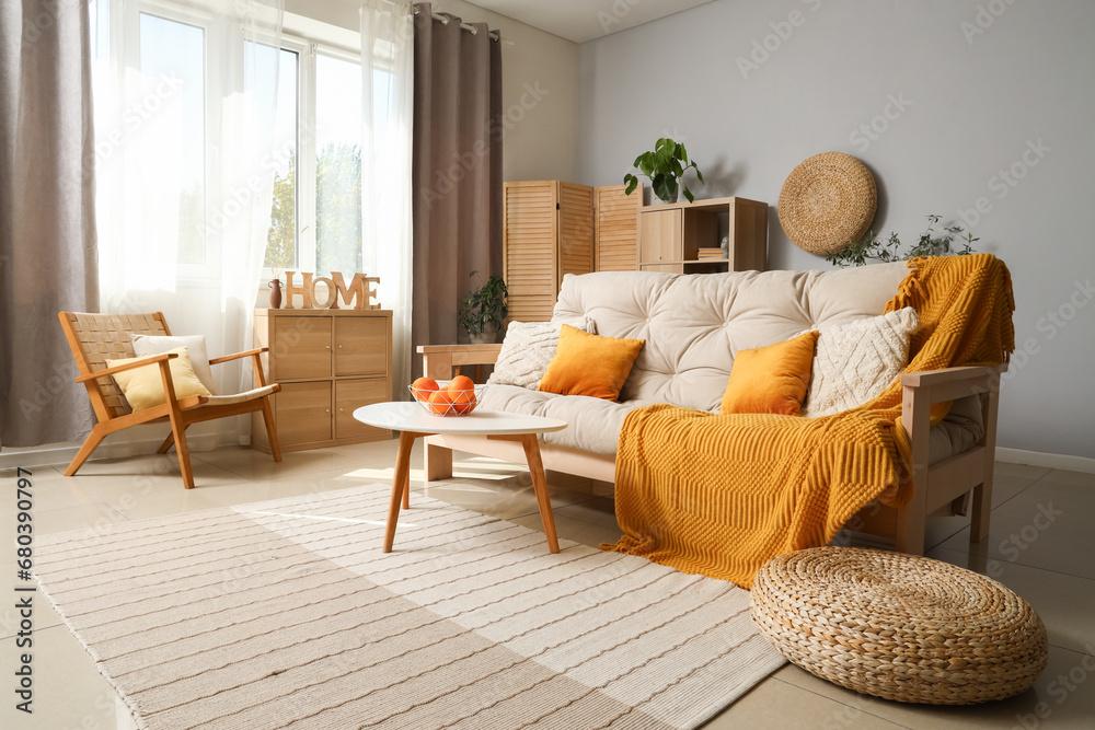 Interior of modern living room with white sofa, coffee table and armchair