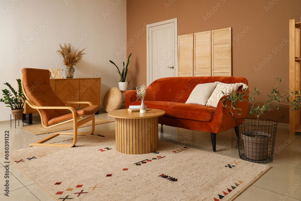 Interior of modern living room with brown sofa, armchair and coffee table