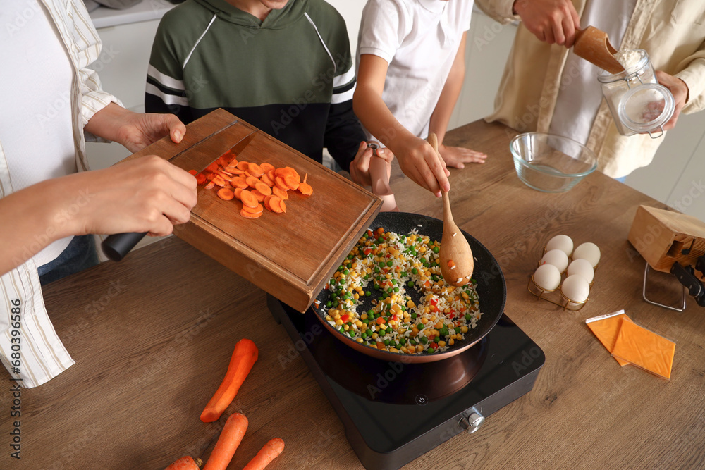 Happy family cooking in kitchen, closeup