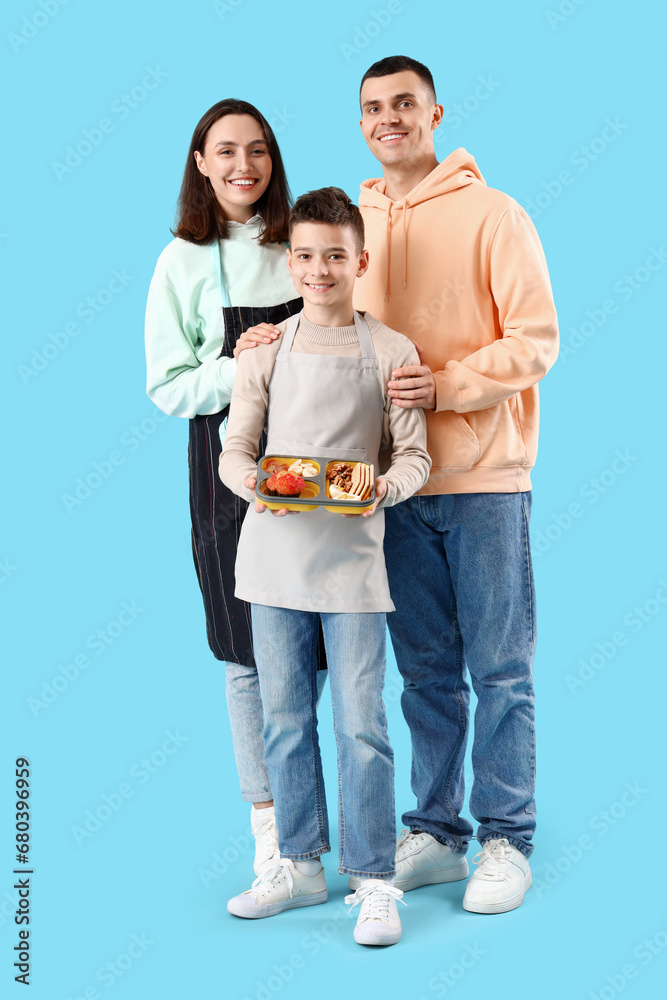 Little boy with lunchbox and his parents on blue background