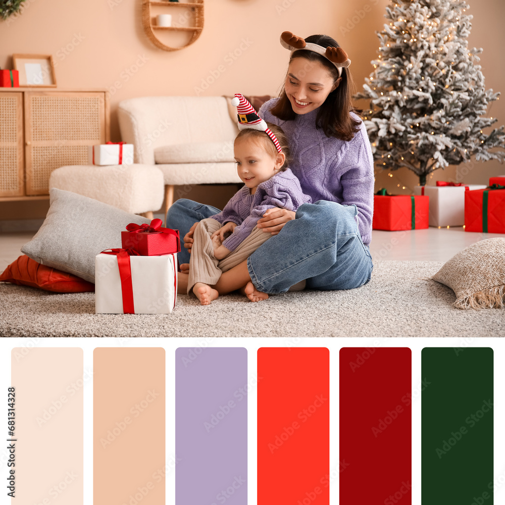 Young mother and her little daughter with Christmas presents at home