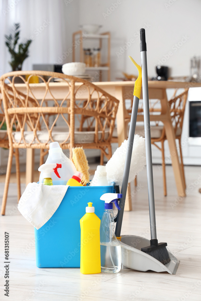 Bucket with cleaning supplies in kitchen