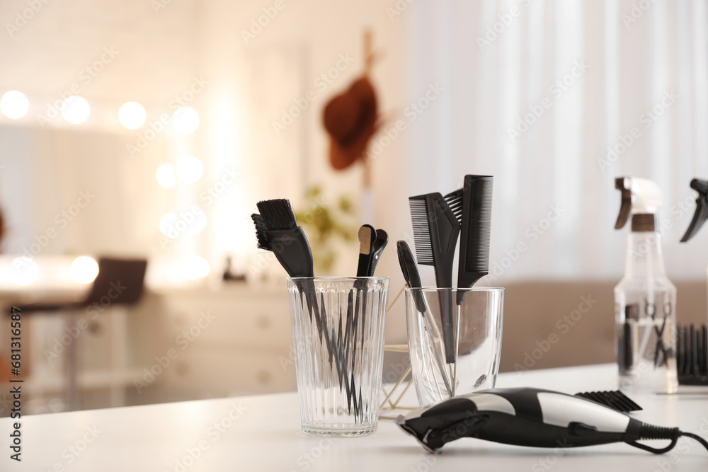 Different hairdressing tools on table in beauty salon