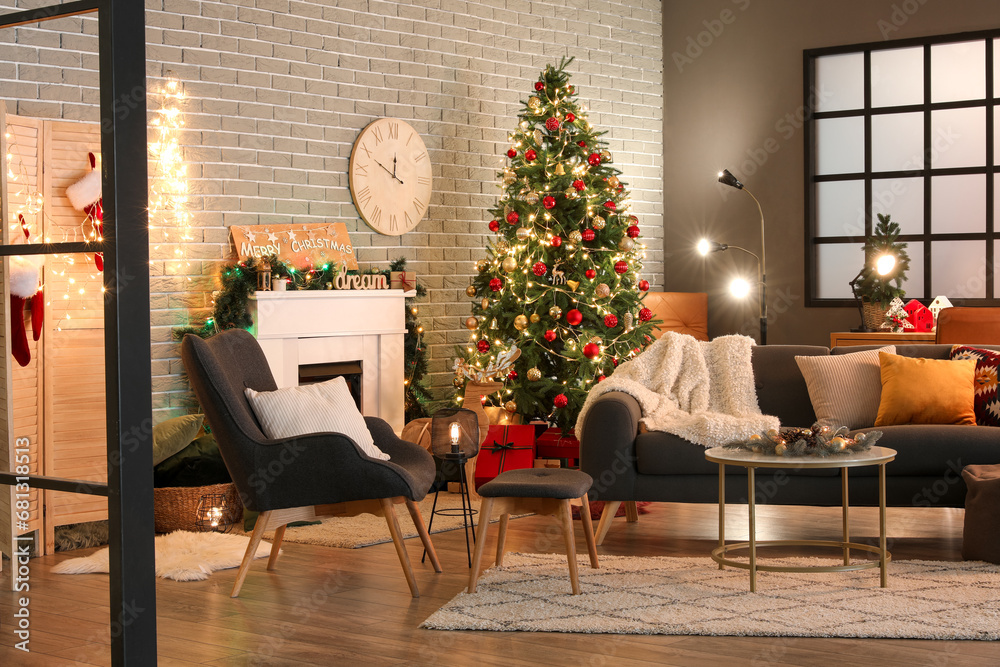 Interior of dark living room with sofa, armchair, fireplace, Christmas tree and glowing lights