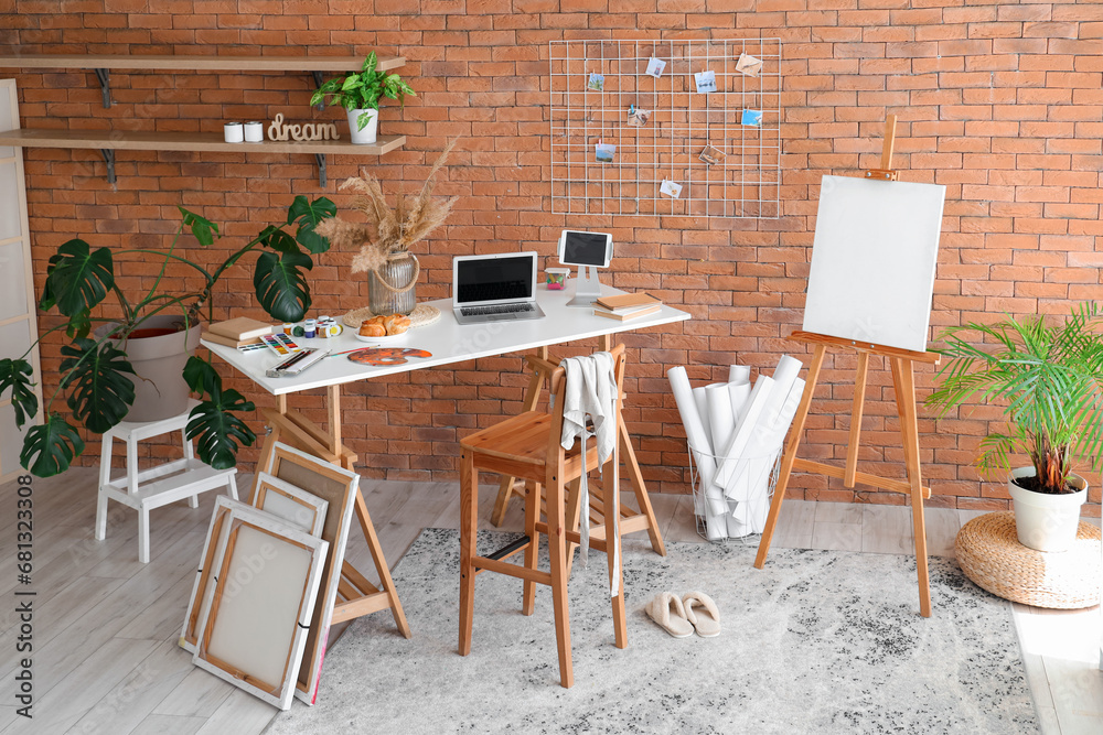 Interior of studio with artists workplace and drawing supplies