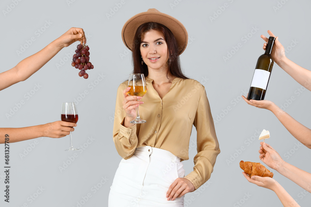 Beautiful young woman receiving food and wine on light background