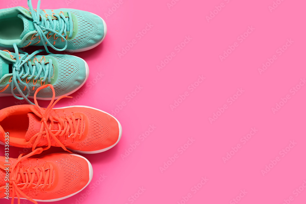 Different stylish sneakers on pink background