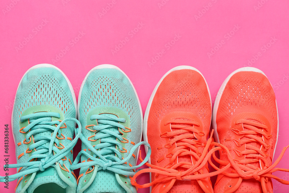 Different stylish sneakers on pink background