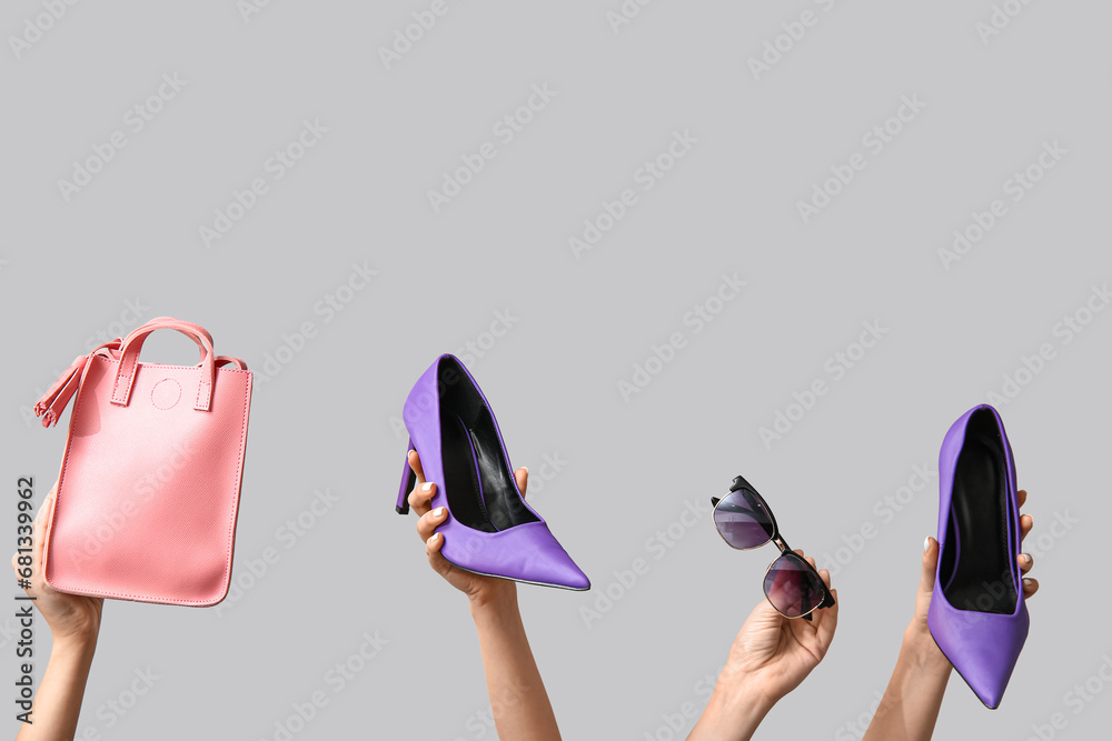 Female hands with women accessories on grey background. Black Friday sale