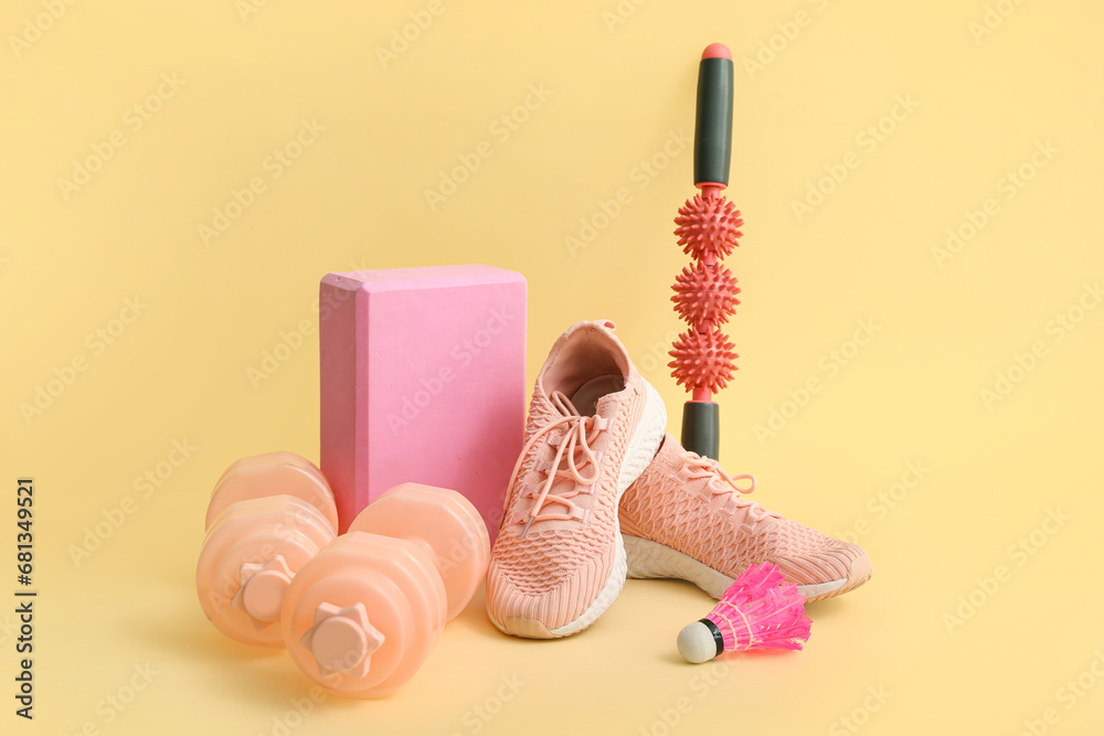 Different sports equipment on yellow background